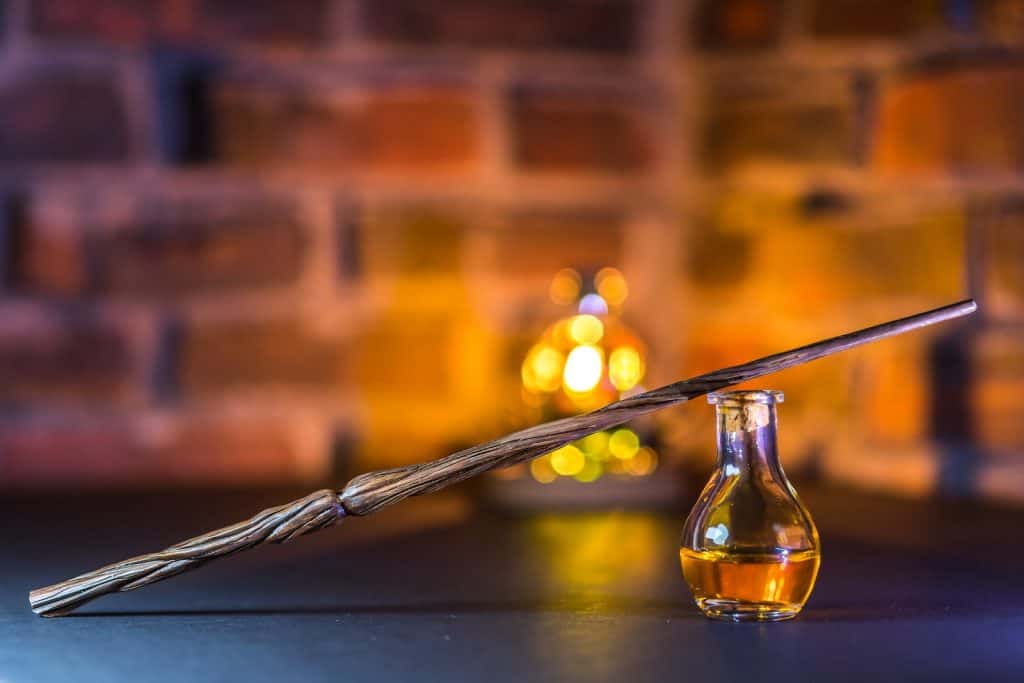 Close-Up Shot of a Wand beside a Potion